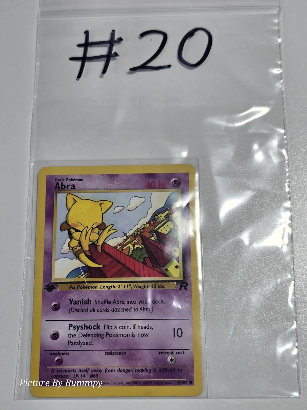 #20 Pokemon 1st Edition Abra card from the Team Rocket set, card number 49/82.